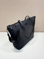 Prada nylon tote bag, angled view, with top handles and adjustable shoulder strap