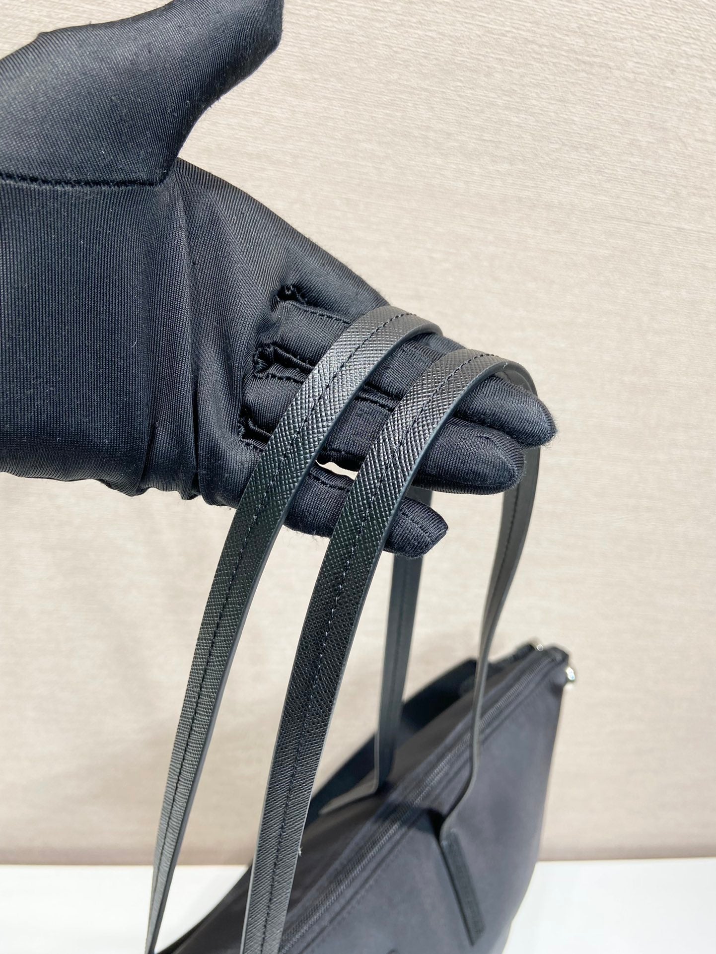 Prada nylon tote bag close-up of strap attachment with woven webbing