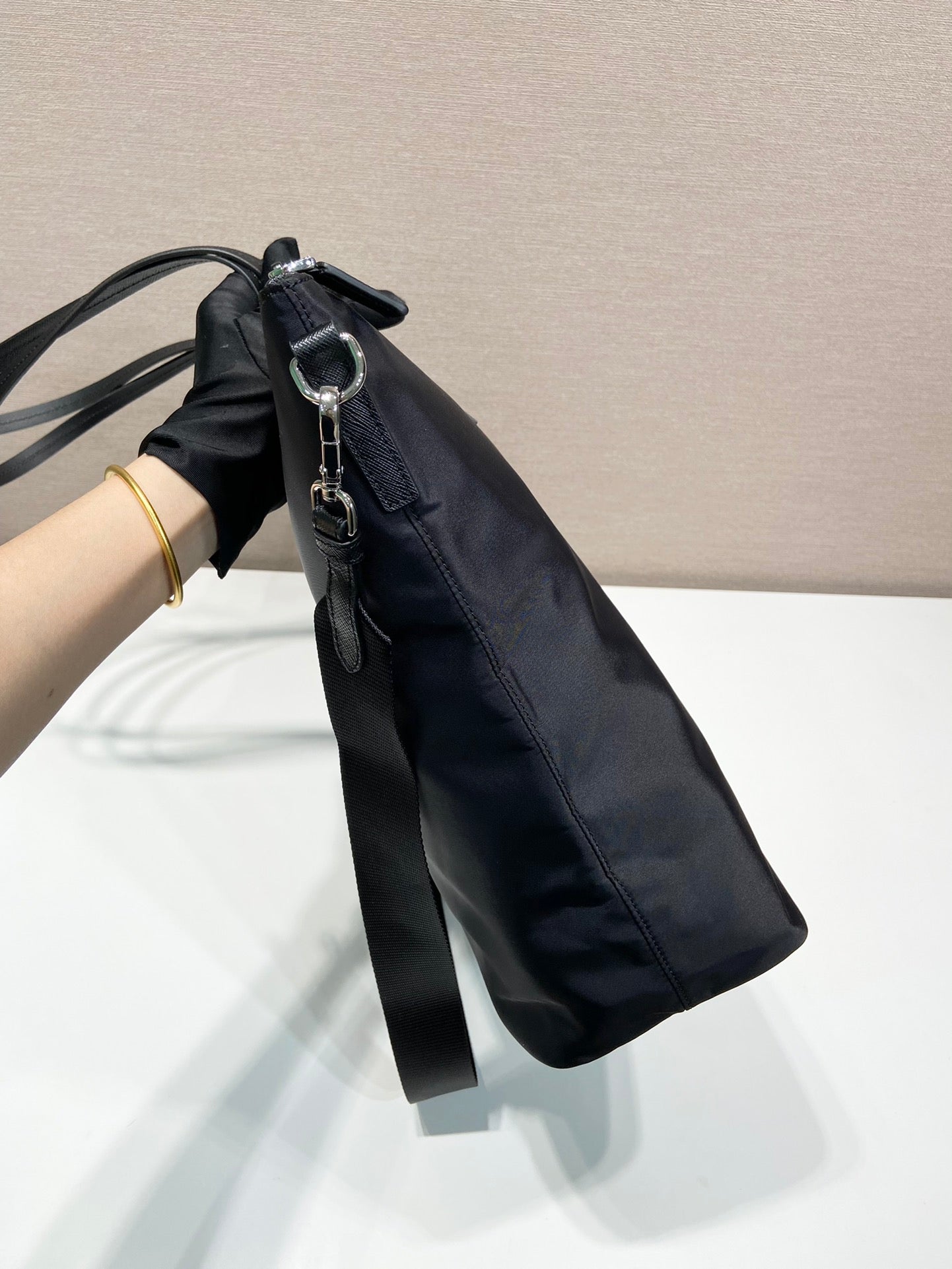 Prada nylon tote bag with hanging strap detail and front zip pull tab