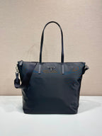 Prada nylon tote bag in dark navy, with top handles and side zip pockets