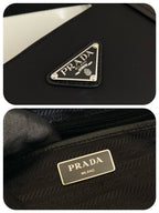 Prada logo plaque and zip pull on dark nylon tote bag