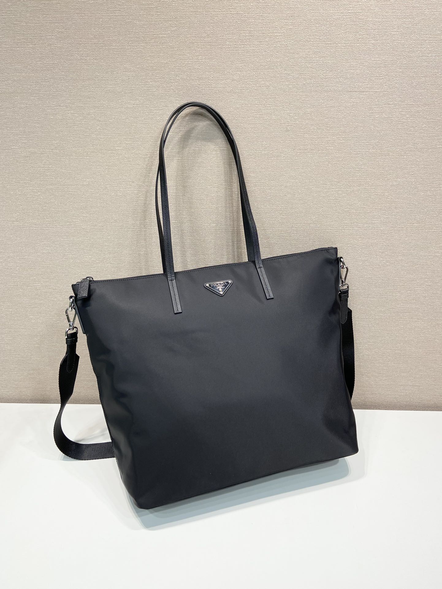 Prada nylon tote bag with top handles and front triangle logo patch