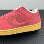 Low-top sneaker quarter view in pink suede with pink swoosh and gum-yellow midsole