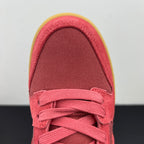 Low-top sneaker toe and laces in pink suede with white laces and yellow edge sole