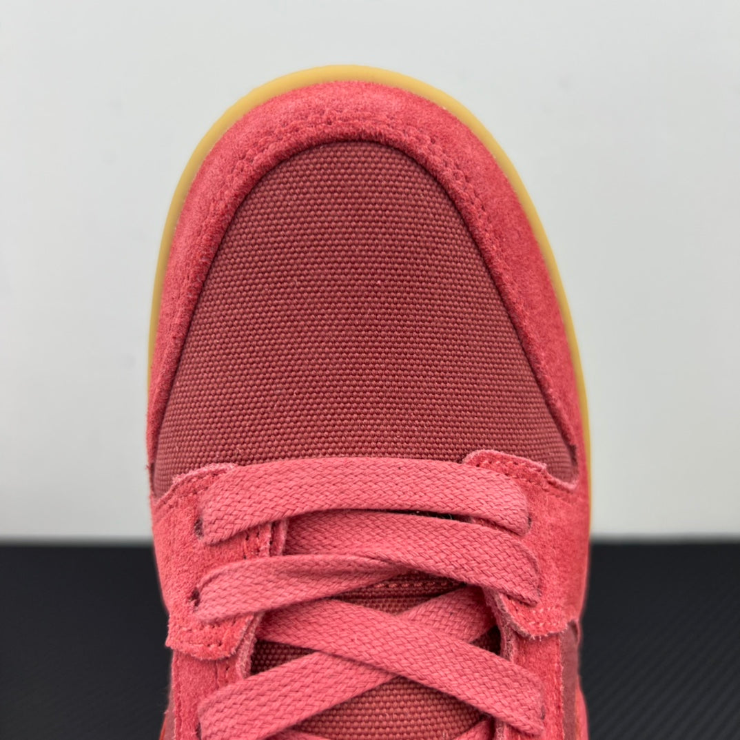Low-top sneaker toe and laces in pink suede with white laces and yellow edge sole