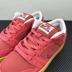 Low-top sneakers with Nike SB tongue labels, pink suede, white laces, yellow sole