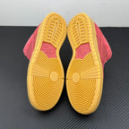 Low-top sneaker outsole view with yellow rubber tread and pink suede heel