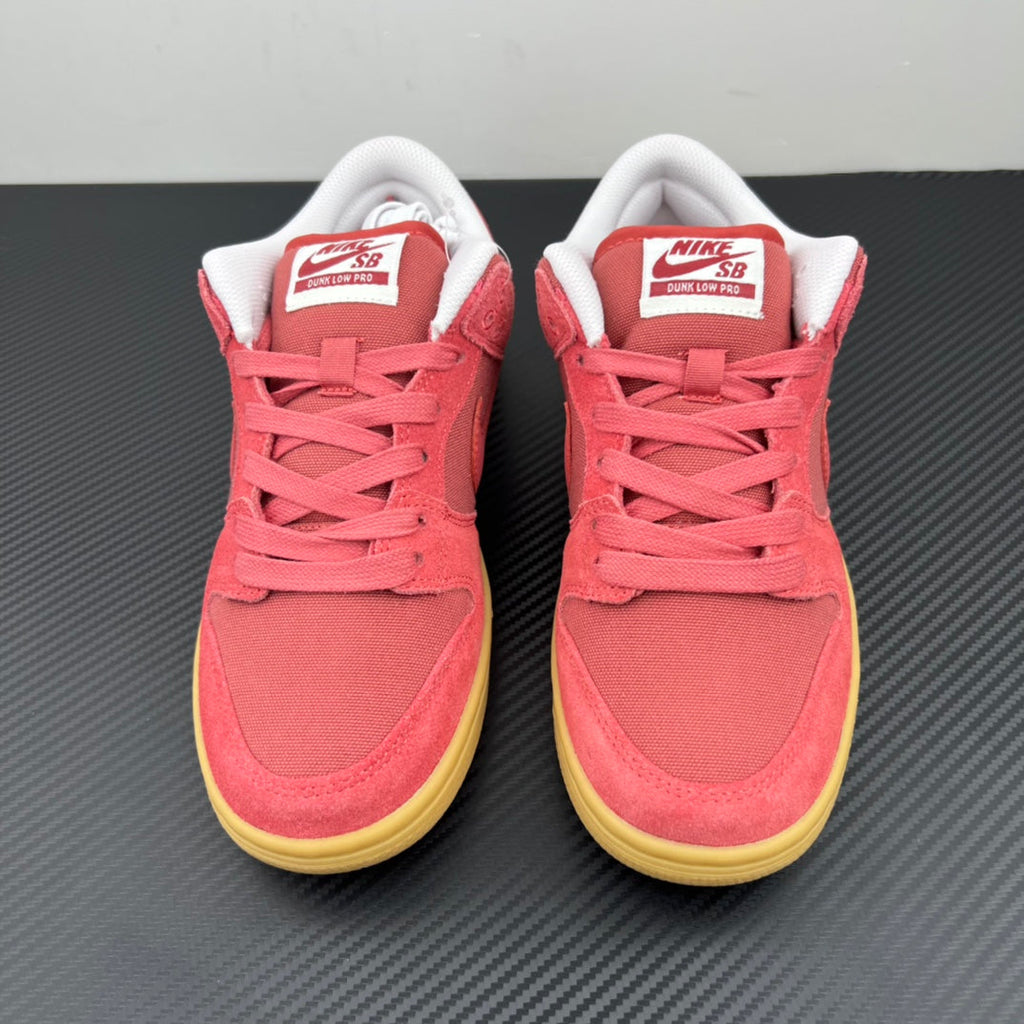 Pair of low-top sneakers with pink suede, white heel collars, and yellow soles