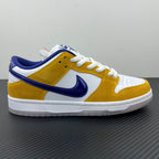 Nike Dunk SB Low Pro low-top sneakers, side view in white, gold and navy with laces