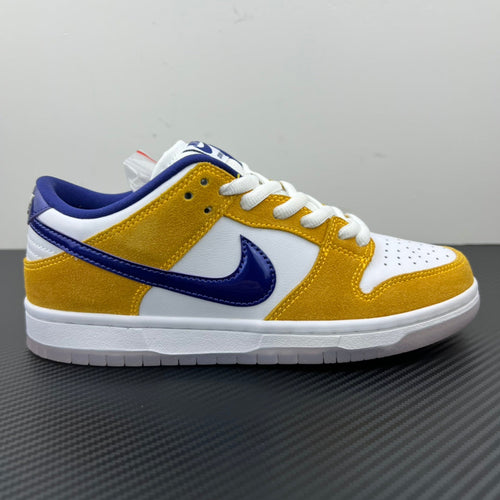 Nike Dunk SB Low Pro low-top sneakers, side view in white, gold and navy with laces