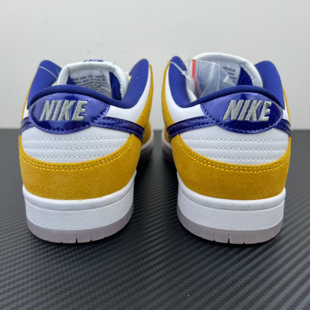 Nike Dunk SB Low Pro sneakers, heel view in white, gold and navy with Nike SB branding