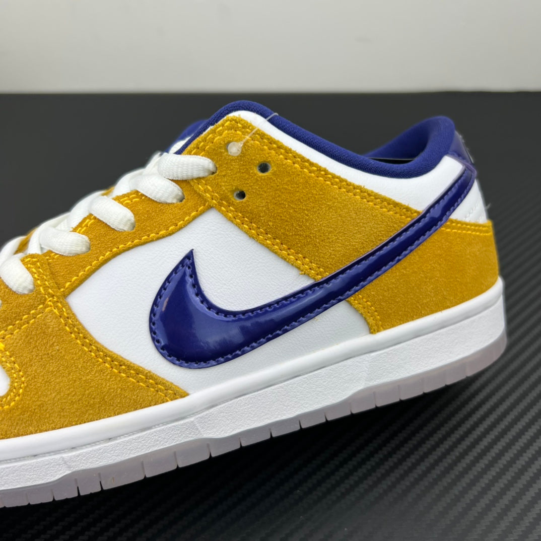 Nike Dunk SB Low Pro sneakers side close-up with navy swoosh and white midsole, gold upper