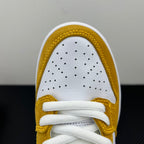 Nike Dunk SB Low Pro toe box close-up in white and gold with perforations and white laces