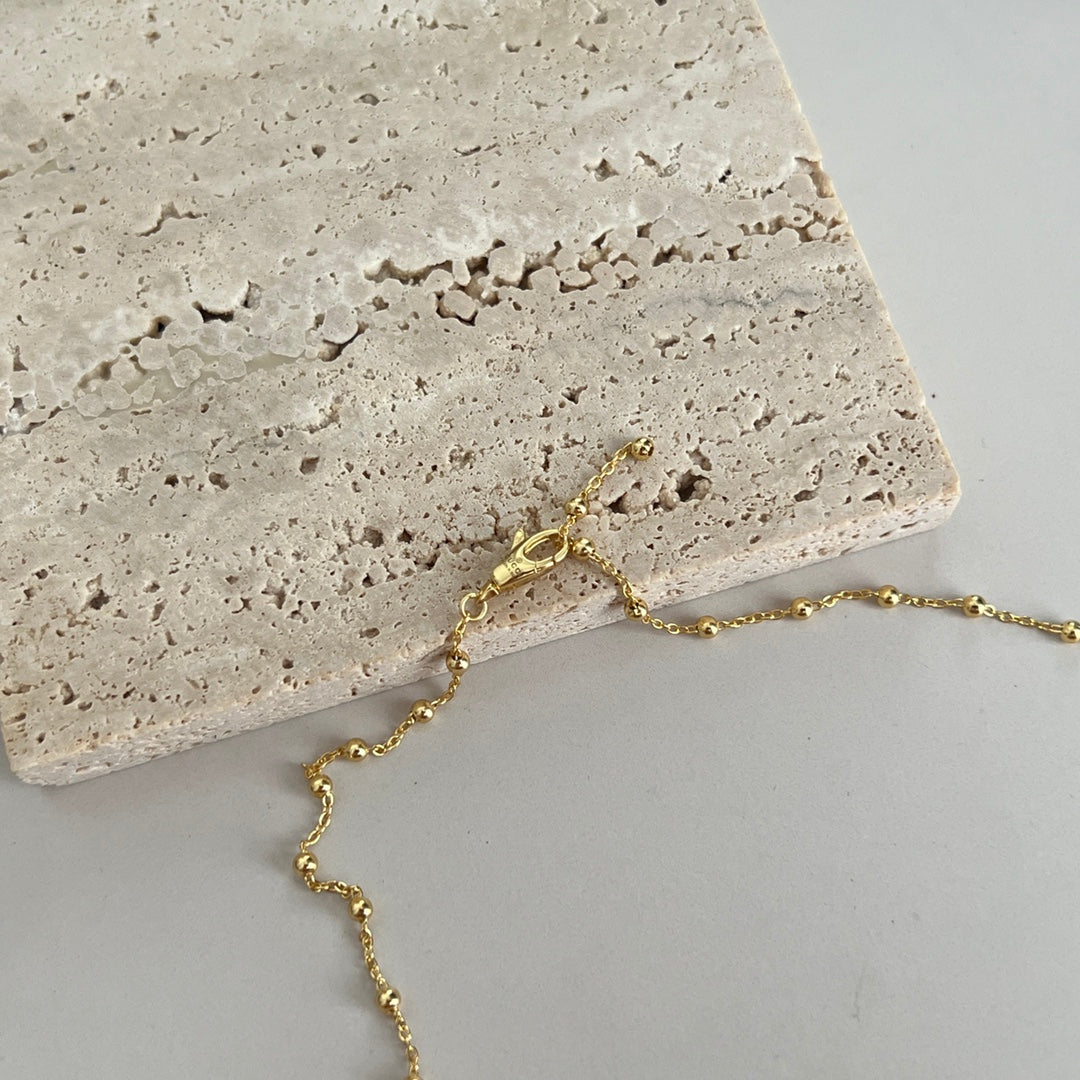 Gucci pendant necklace with gold chain and round logo charm pendant