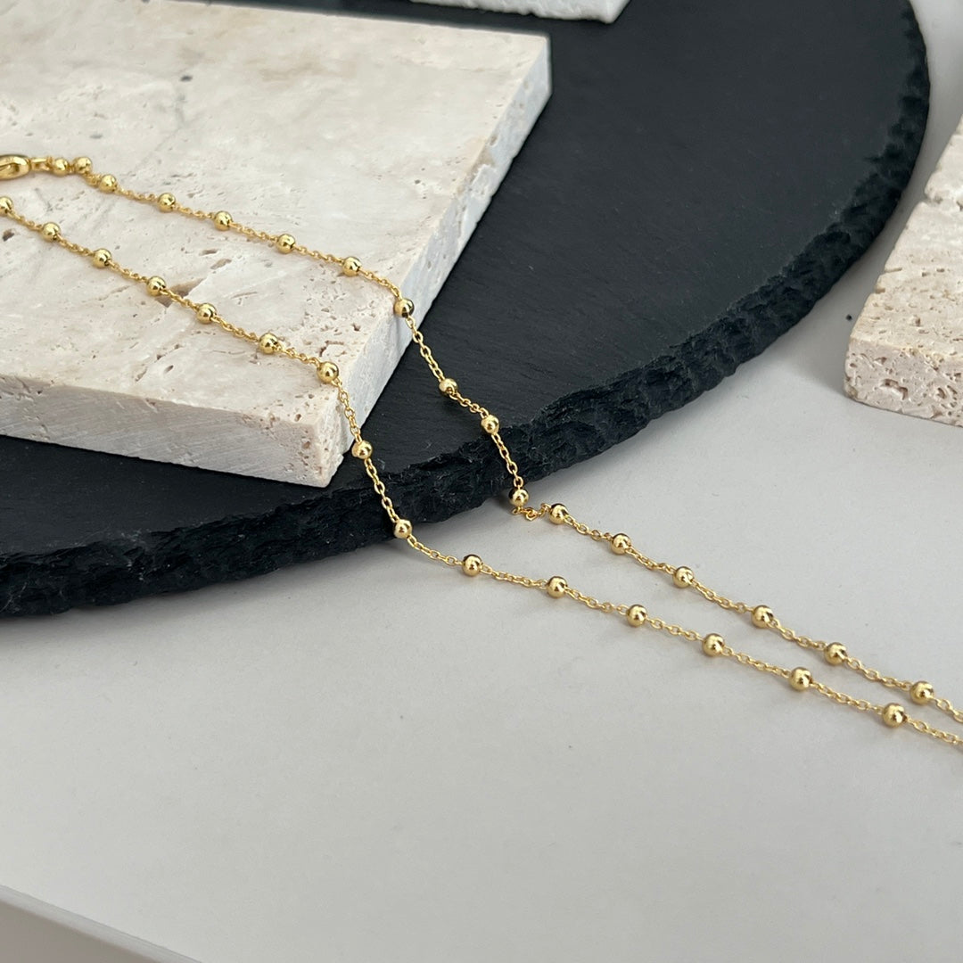 Gucci pendant necklace with fine gold chain and small round logo charm