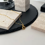 Gucci pendant necklace with gold chain and small round logo charm