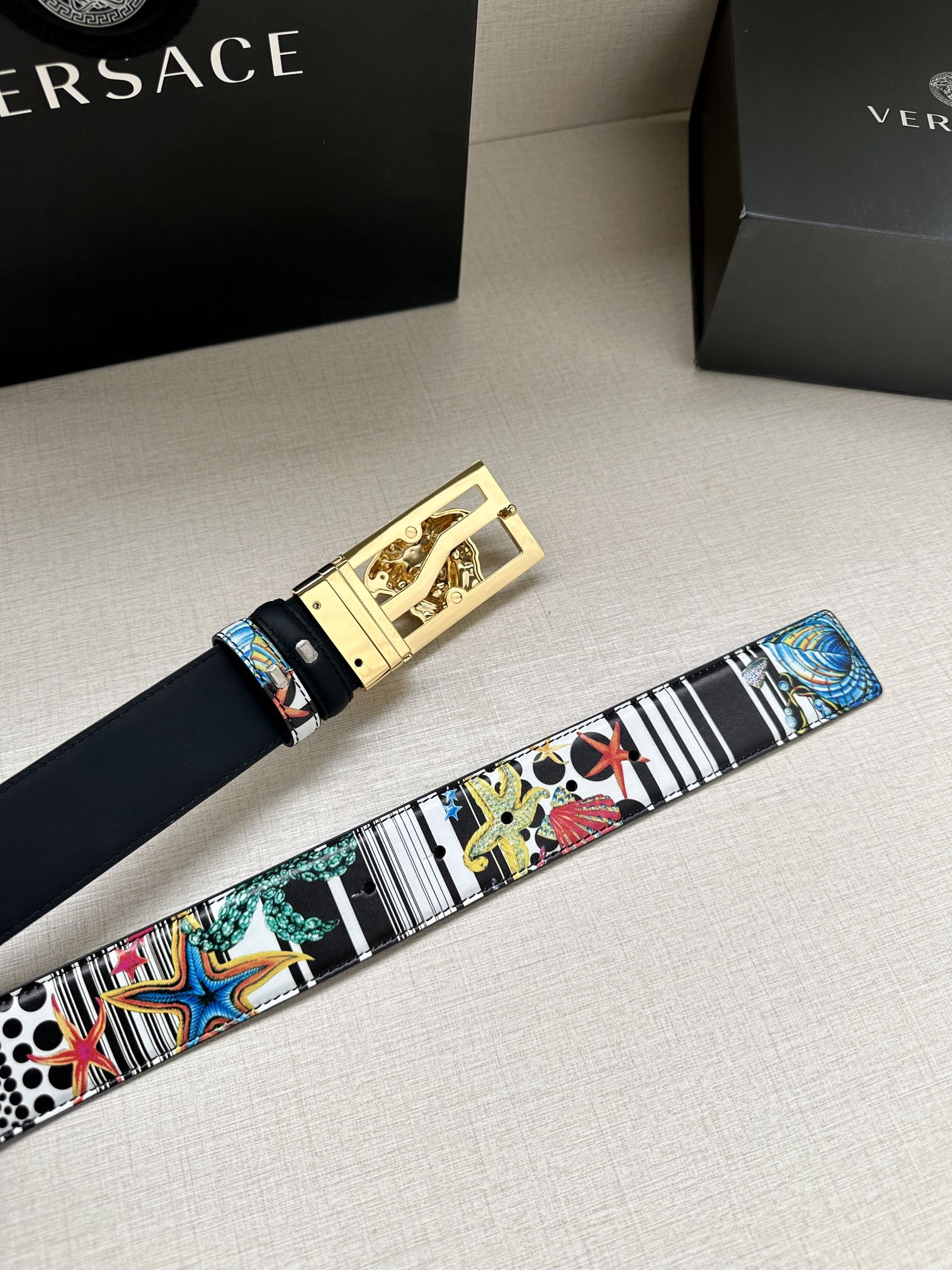 Versace belt with multicolor graphic strap and gold rectangular buckle