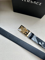 Versace belt with dark strap, small stud holes, and gold-tone Medusa buckle