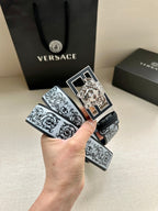 Designer belt with baroque pattern strap and gold square buckle featuring Medusa