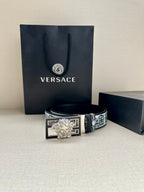 Designer belt with patterned strap and silver Medusa buckle