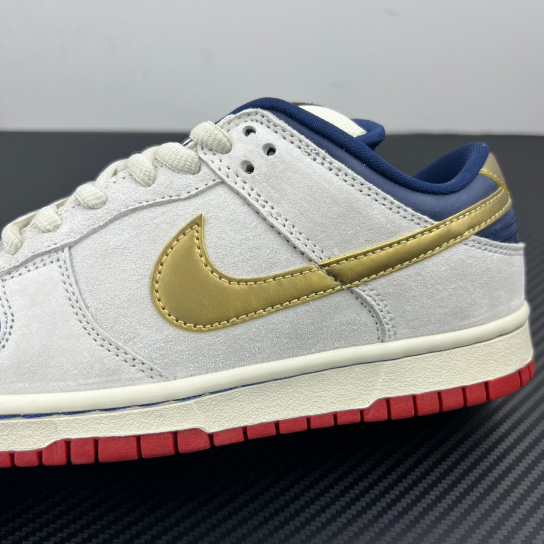 Side profile of low-top sneaker in light gray/white with gold swoosh and red outsole.