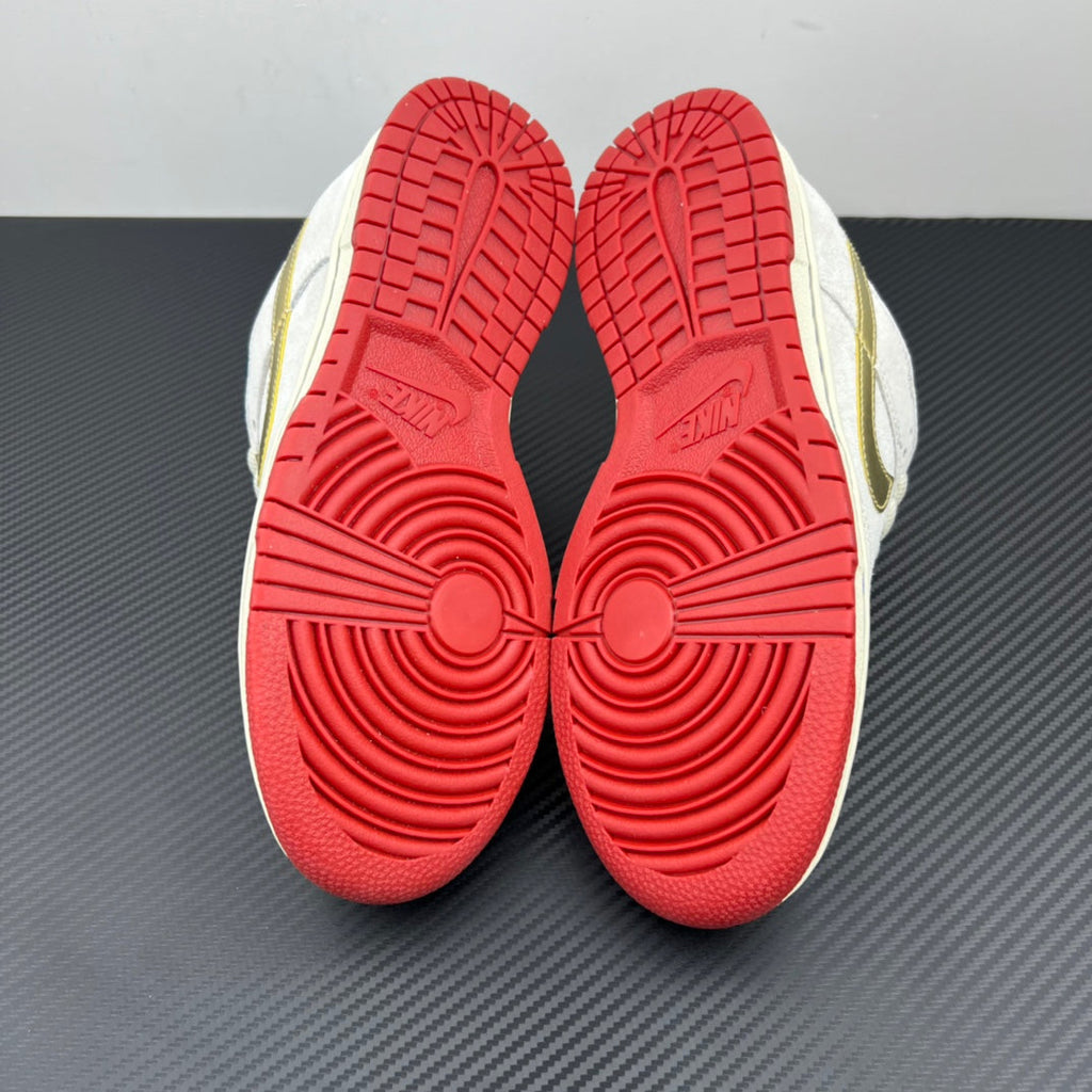 Shoe outsoles in red with circular tread pattern on white and navy sneakers.