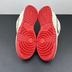 Shoe outsoles in red with circular tread pattern on white and navy sneakers.