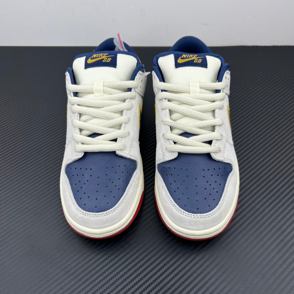 Pair of low-top sneakers with white uppers, navy perforated toe boxes, blue collars.