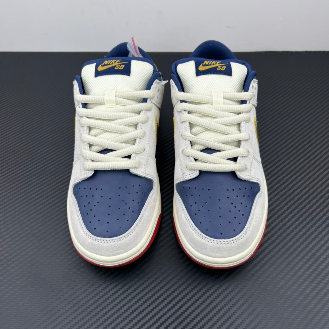 Pair of low-top sneakers with white uppers, navy perforated toe boxes, blue collars.