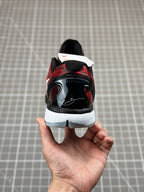 Rear view of red and black basketball shoe, lace-up back heel with white tag