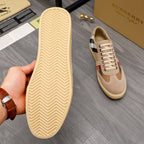Burberry sneaker outsole view: beige rubber sole with textured traction, plus shoe side