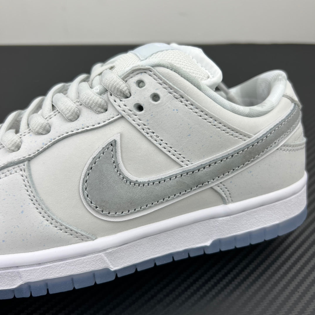 White low-top sneaker side profile with light-gray swoosh and stitched edging.