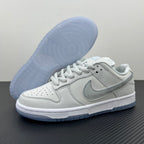 White low-top sneaker with visible light-blue outsole tread and lace-up upper.