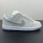White low-top sneaker, front quarter view with lace-up and perforated toe box.