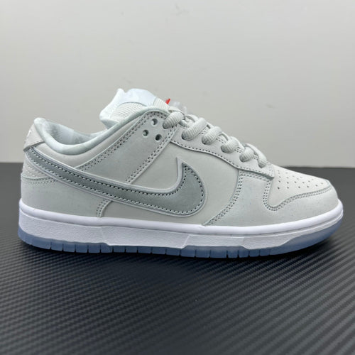 White low-top sneaker, front quarter view with lace-up and perforated toe box.