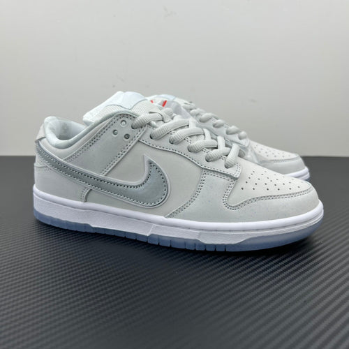 White low-top sneaker with light-gray swoosh, lace-up, blue-tinted outsole.
