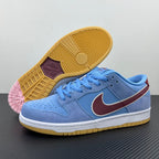 Light blue low-top sneakers showing yellow gum outsole and pink outsole detail