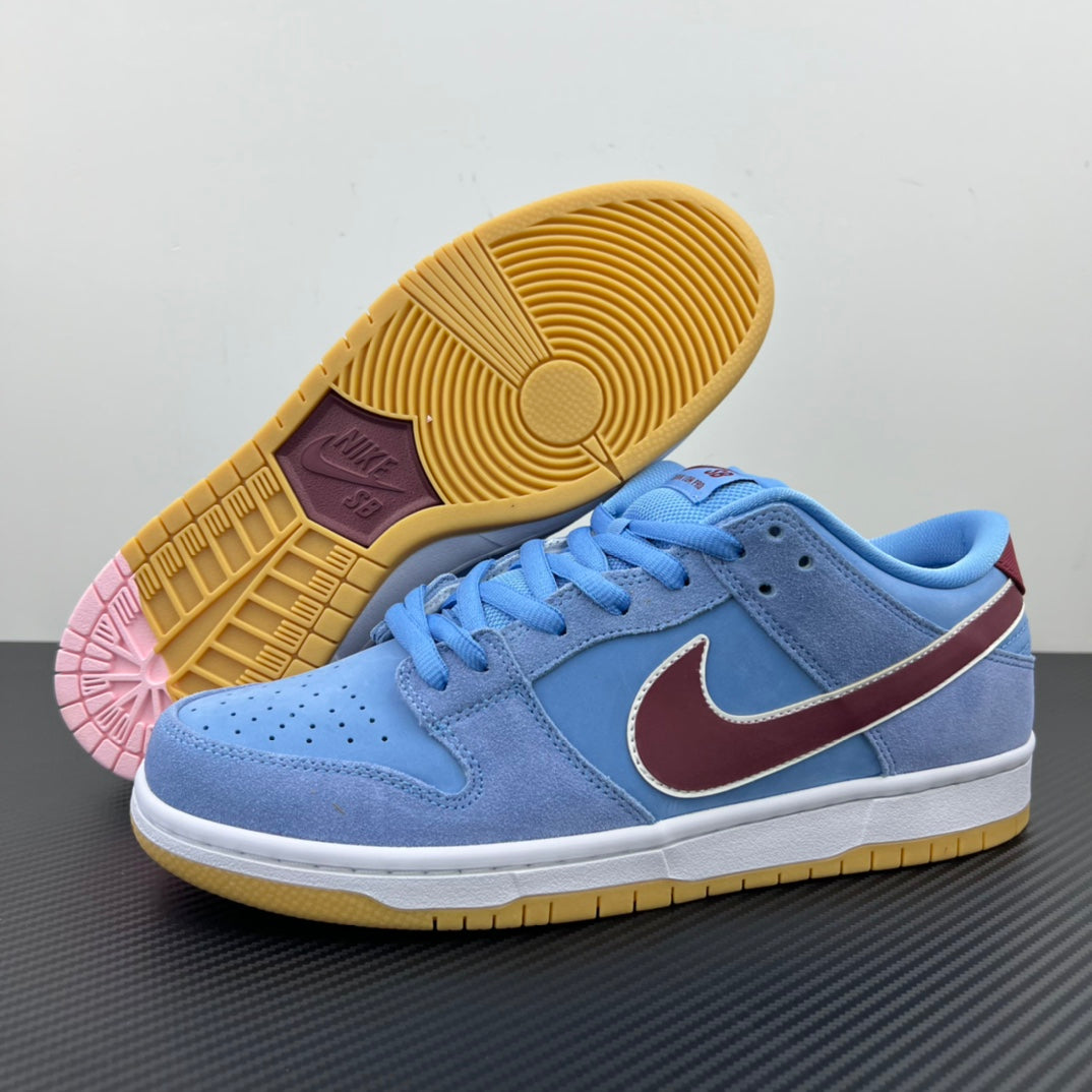 Light blue low-top sneakers showing yellow gum outsole and pink outsole detail