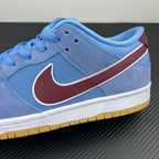 Light blue low-top sneaker side with maroon Swoosh and white midsole