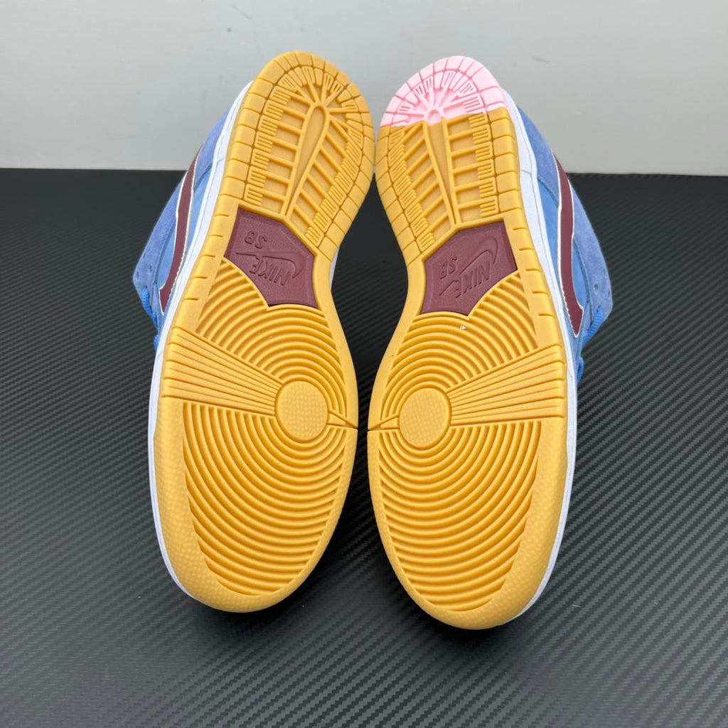 Pair of light blue sneakers with yellow gum outsoles and patterned traction
