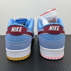 Pair of light blue sneakers with maroon NIKE heel tabs and white midsole