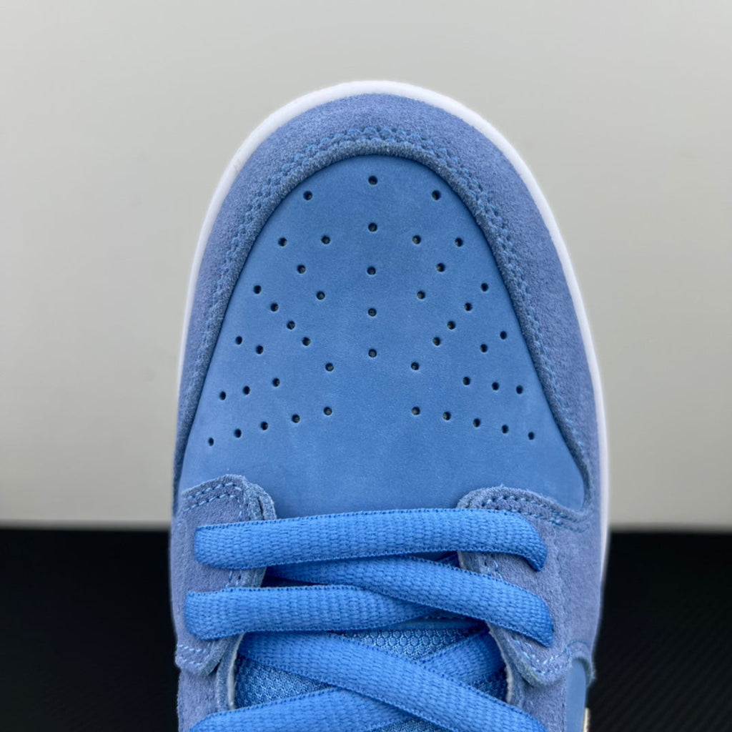 Light blue suede sneaker toe with perforations and blue lace panel