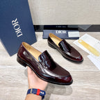 Dior unisex patent leather loafer pair, dark burgundy slip-on with strap