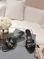 Black leather slide sandals with double straps and silver buckle hardware