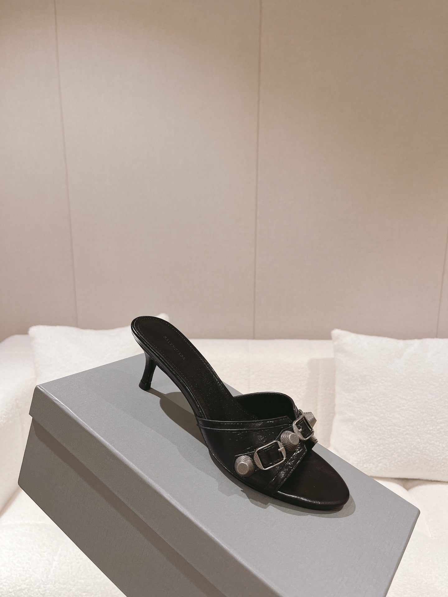 Black leather heeled slide sandals with silver buckle strap and low heel