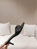 Black leather heeled mule sandal with silver buckle strap and chunky heel