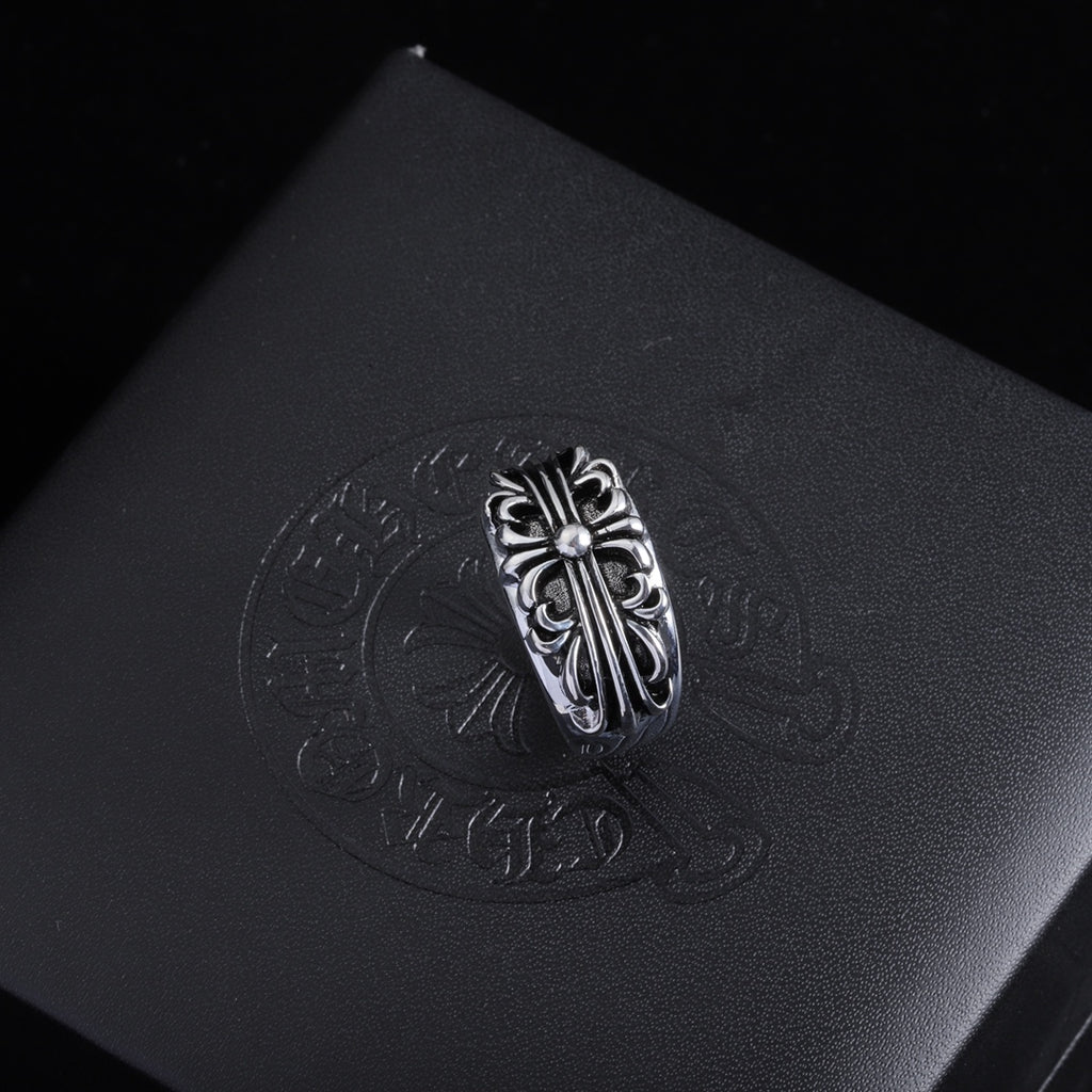 Silver-tone filigree chrome ring with a decorative oval crest and raised details.