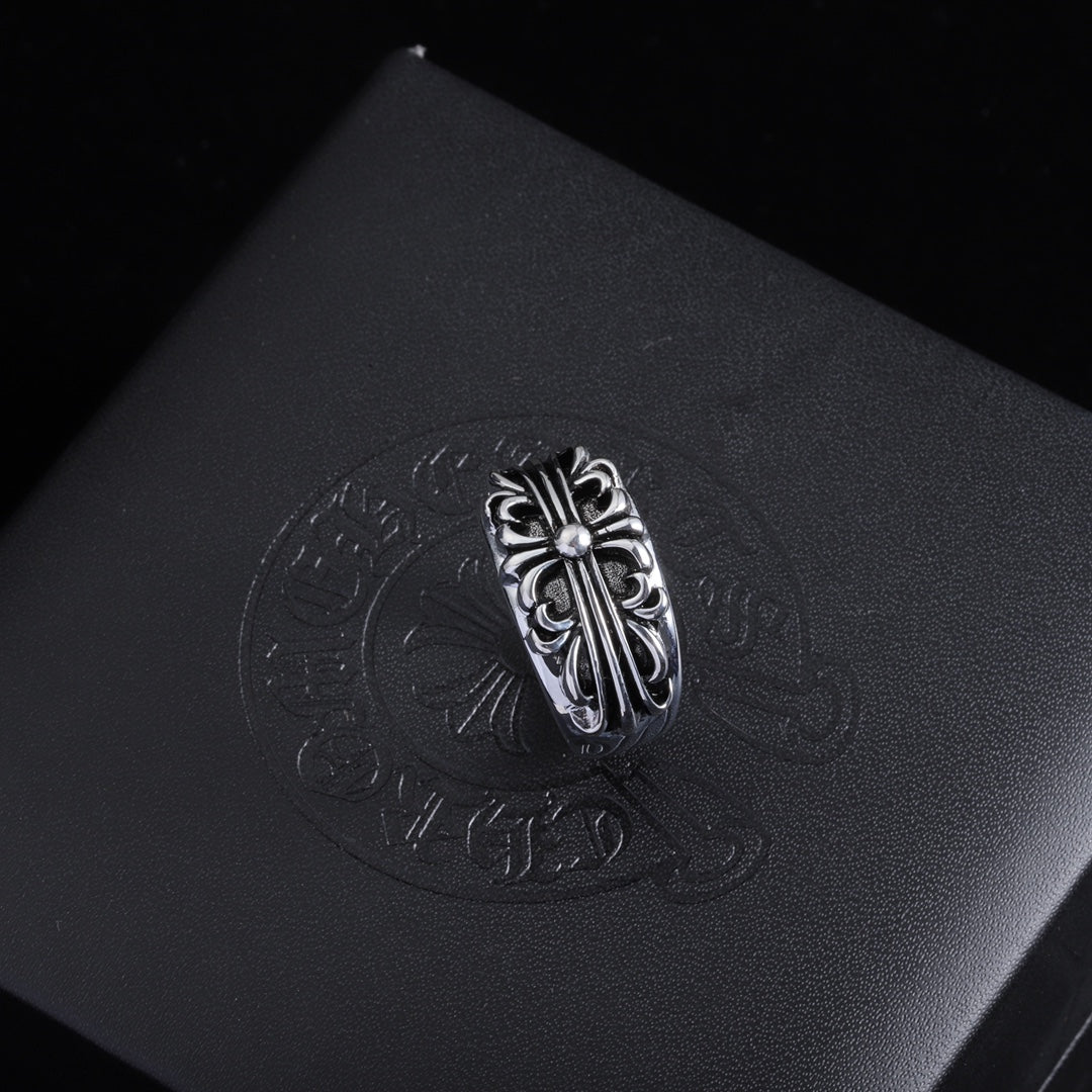 Silver-tone filigree chrome ring with a decorative oval crest and raised details.