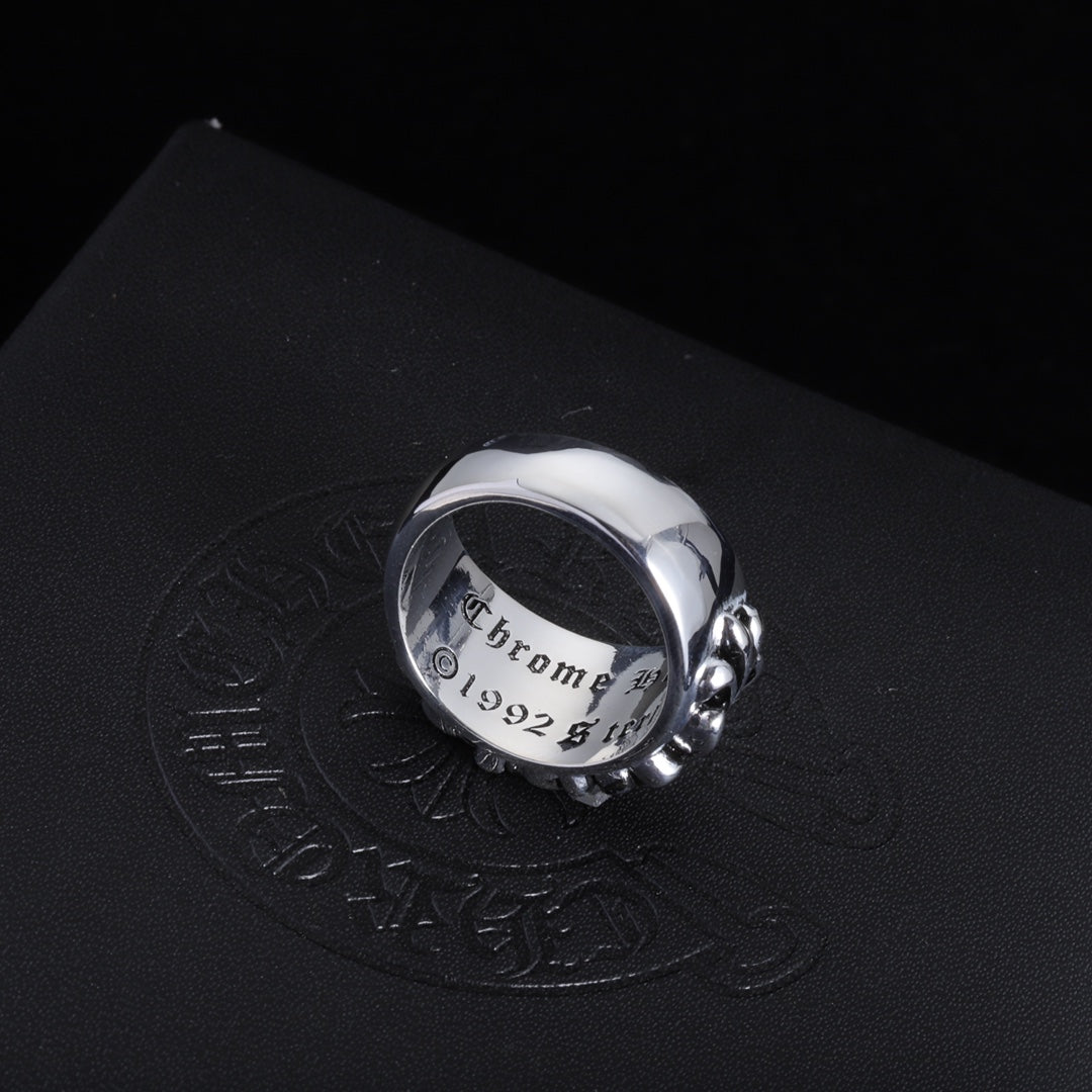 Silver-tone chrome ring shown from the side with ornate filigree detailing.