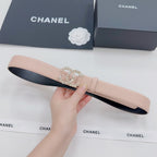 Light pink leather belt with black underside and ornate rhinestone buckle detail